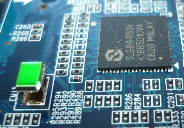 Portable envy on a clock generator circuit board (lower left). Note the classic "green with envy" glow.